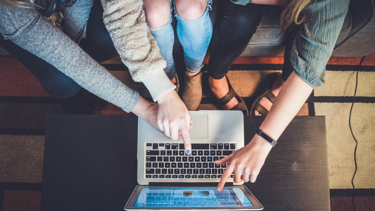A group working together around a laptop
